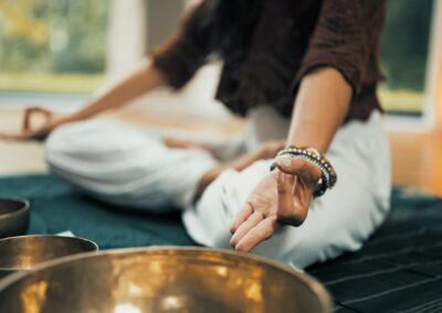 person in white dress shirt and brown vest wearing silver bracelet